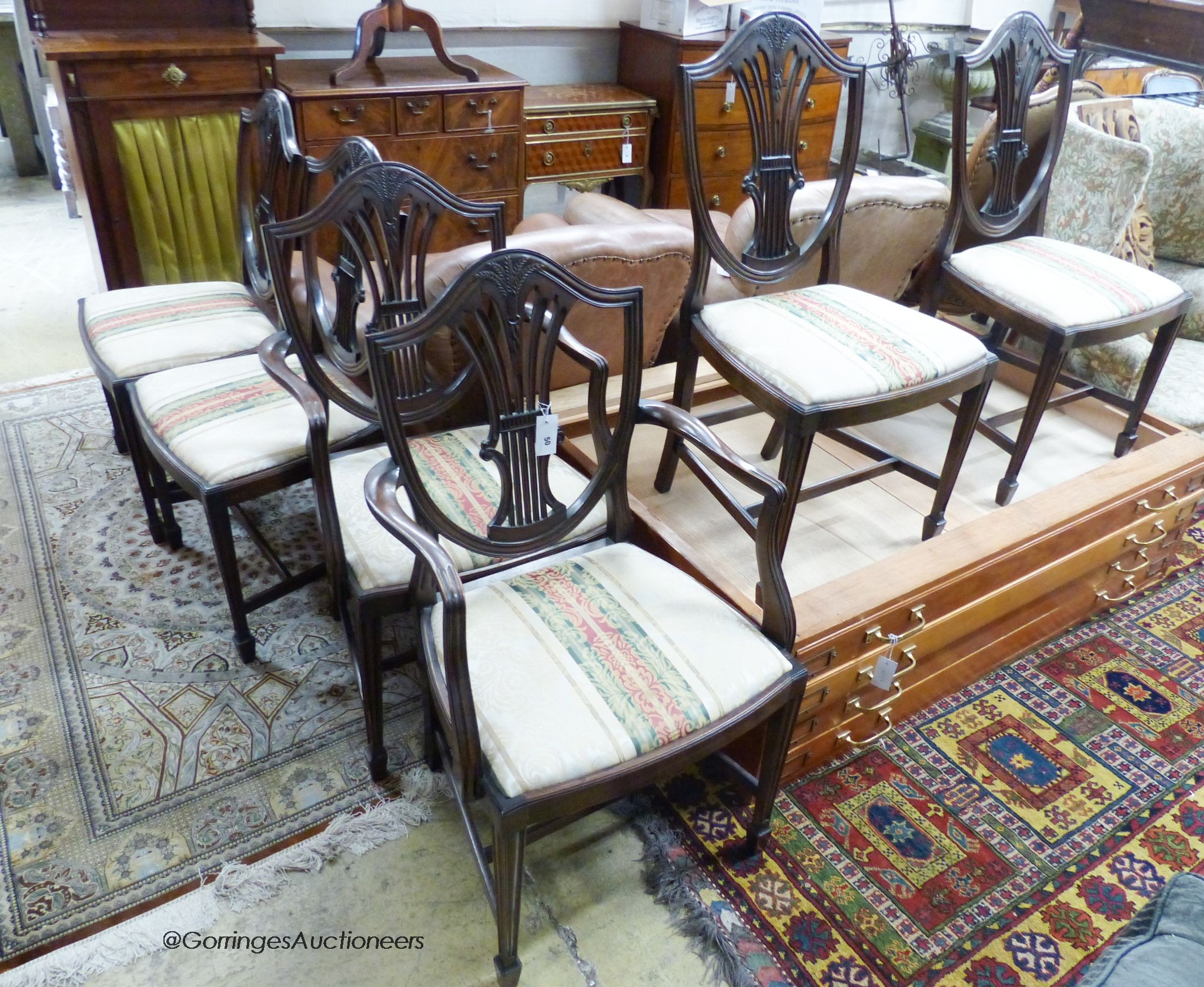 A set of six Hepplewhite style mahogany dining chairs, two with arms